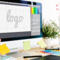 Computer monitor displaying graphic design program with the word logo on the screen.