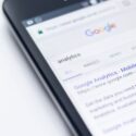 Closeup of mobile screen displaying a Google search for analytics.