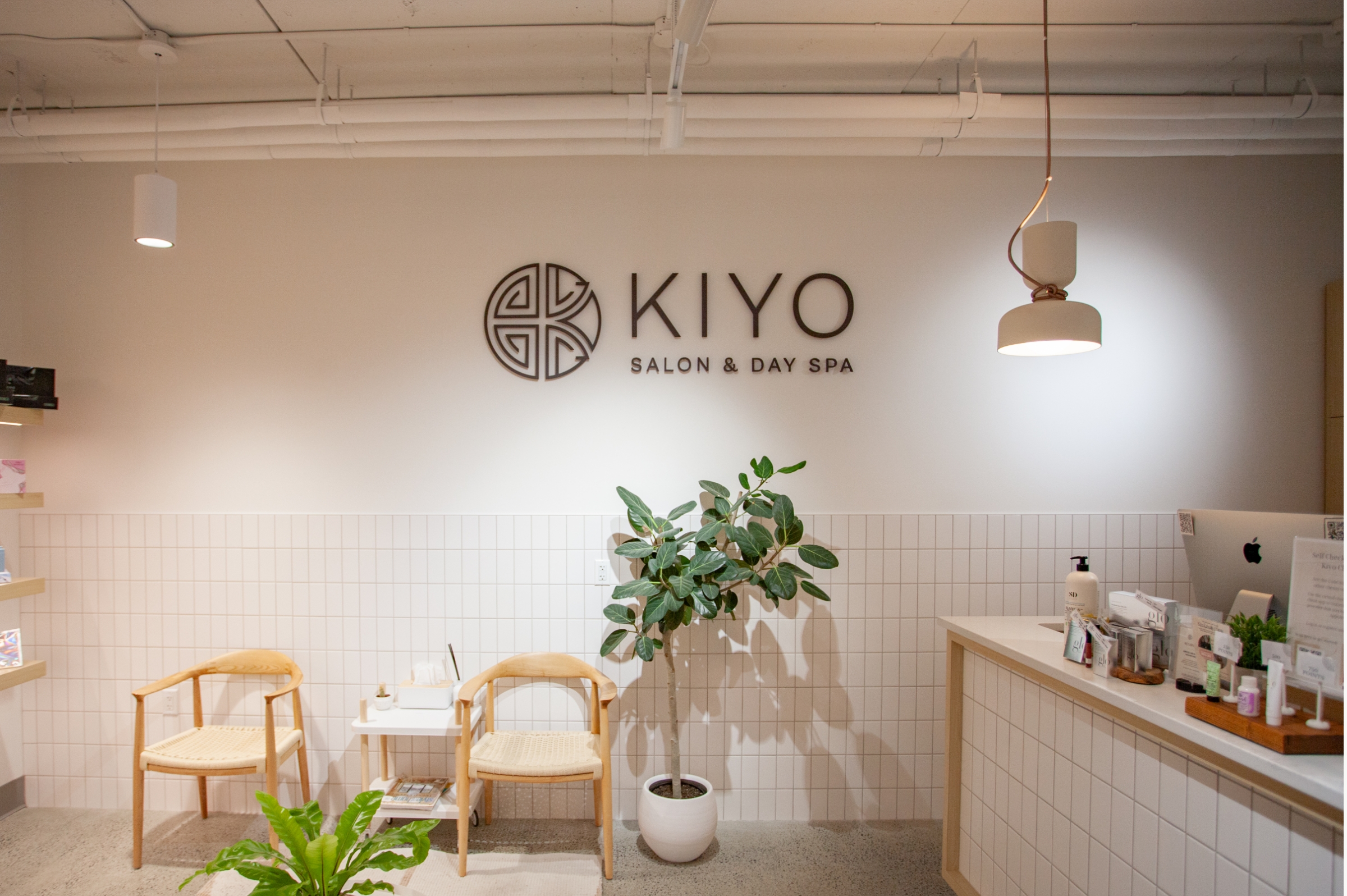 Environmental graphic design by Array Ad Agency in Nanaimo. Day spa reception area with House of Kiyo logo and sign pin-mounted on the wall.