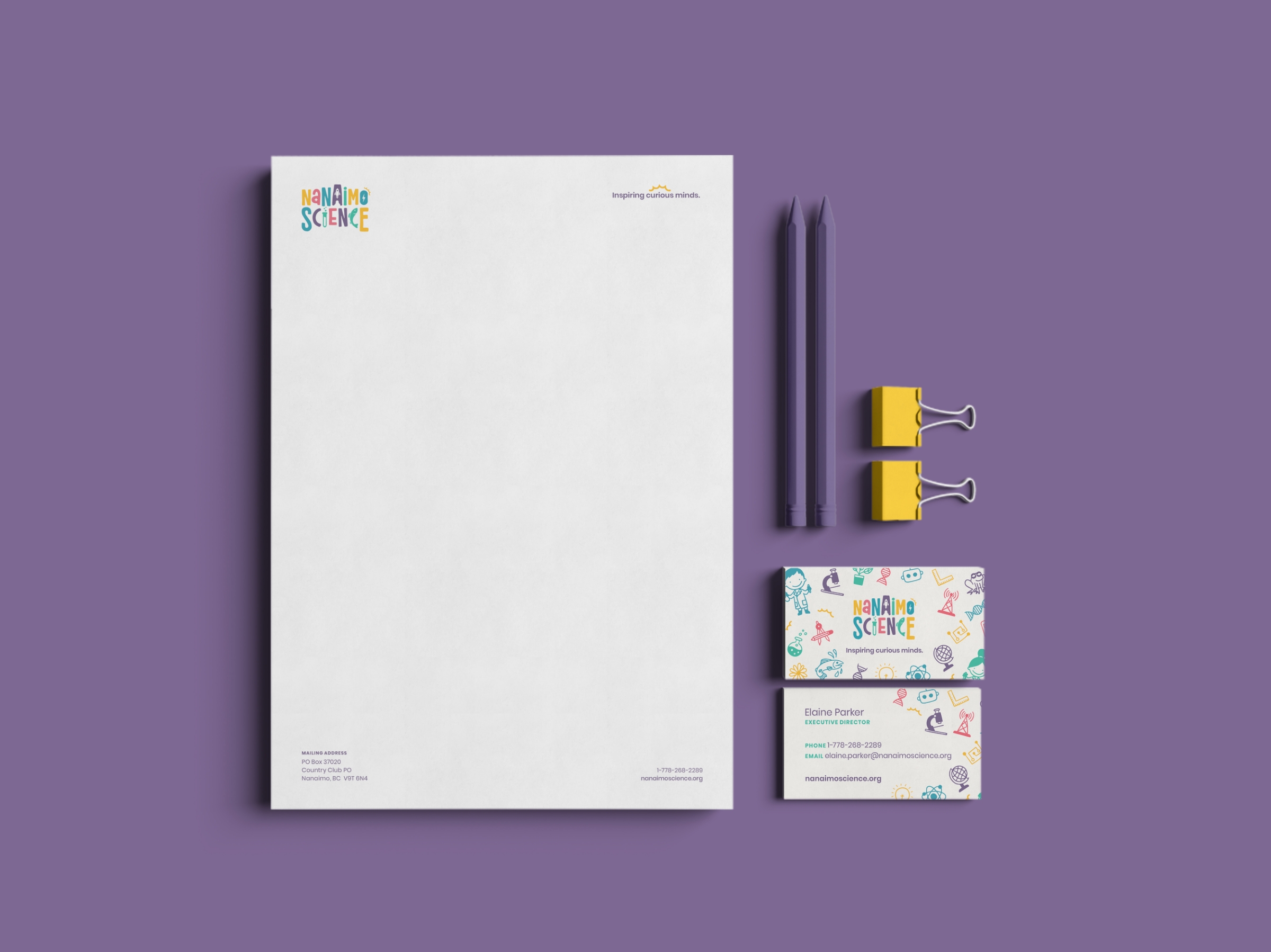 Printed brand collateral for Nanaimo Science, including business cards and letterhead showcasing their updated visual identity.