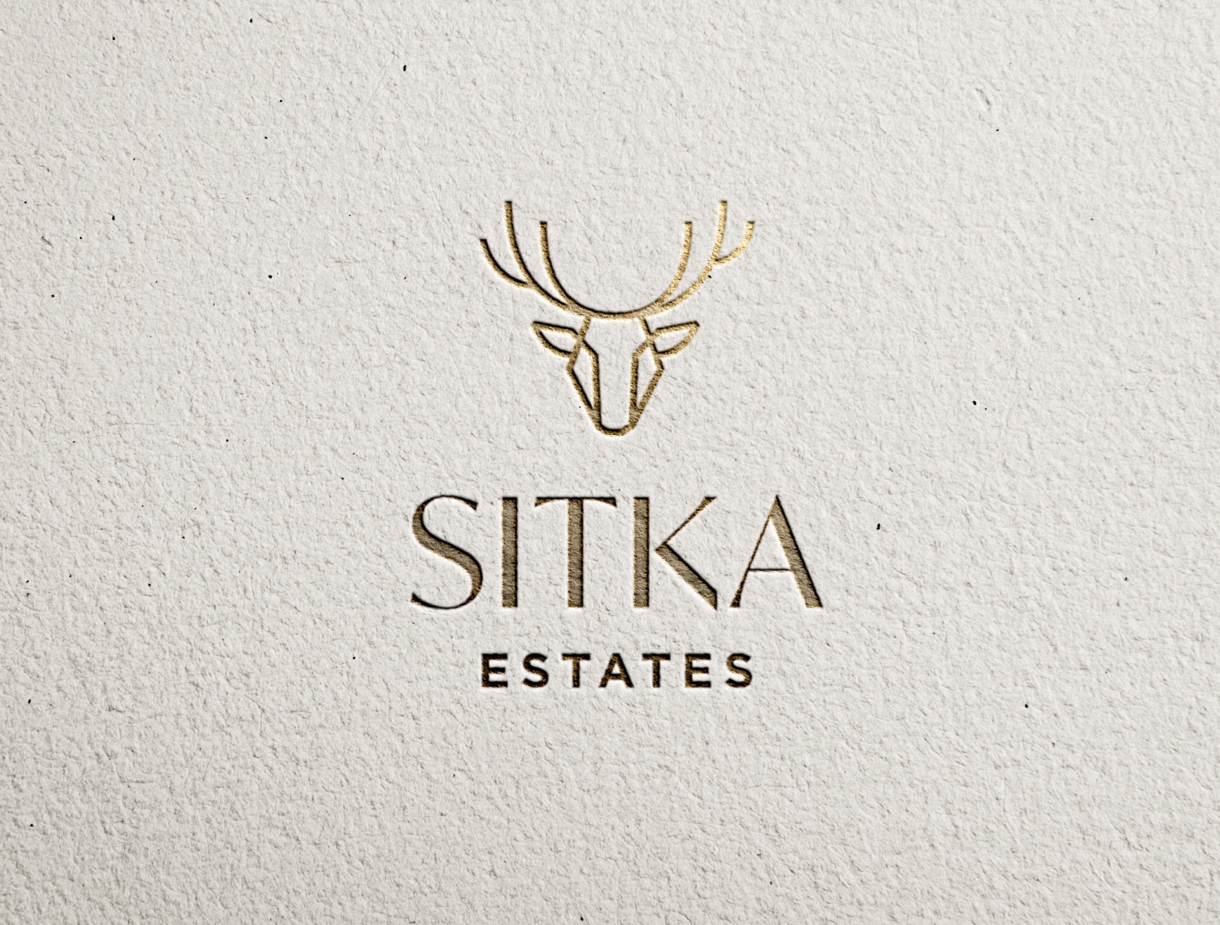 Sitka Estates logo design on a textured background.