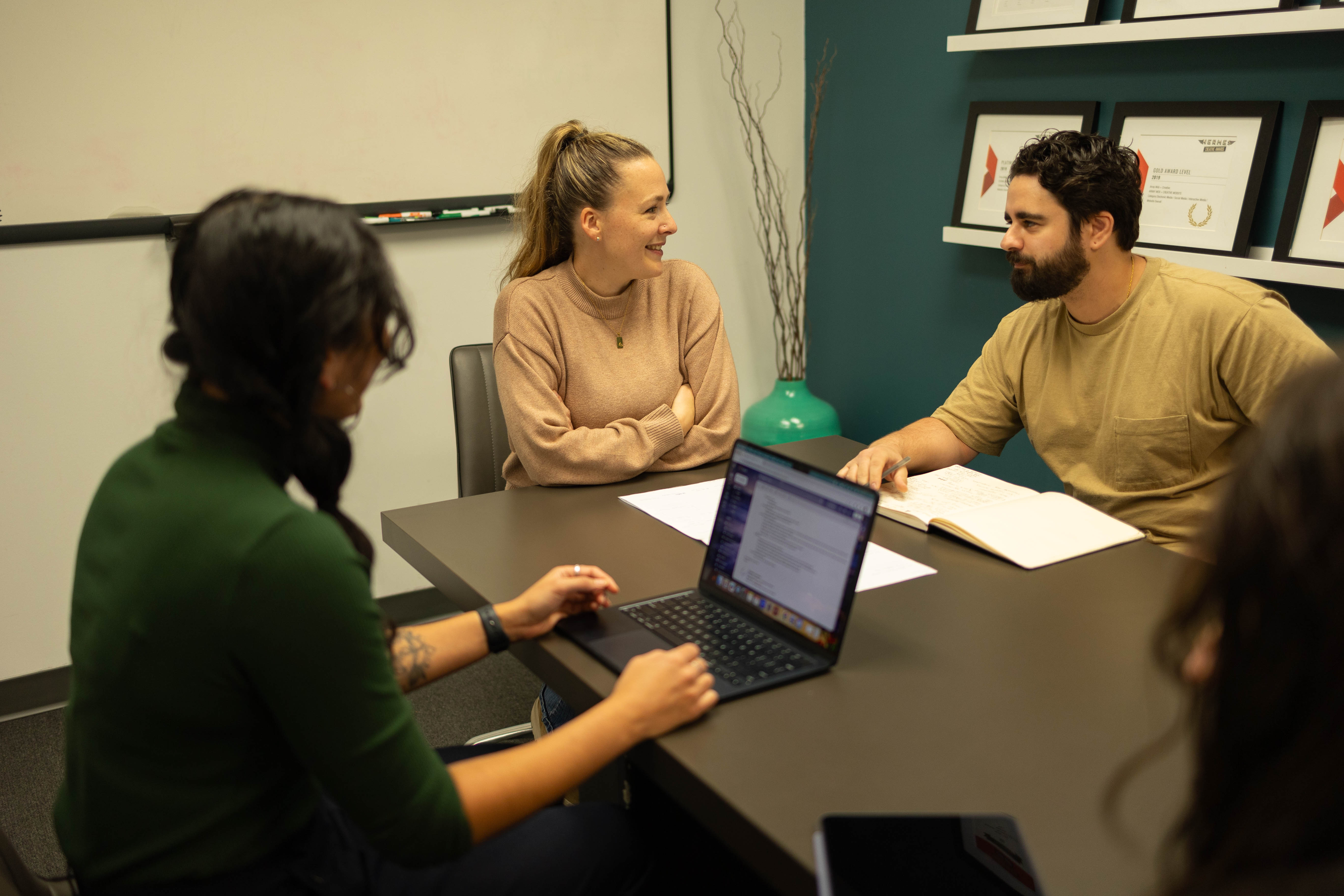 3 members of Array Marketing Agency having a meeting and collaborating.