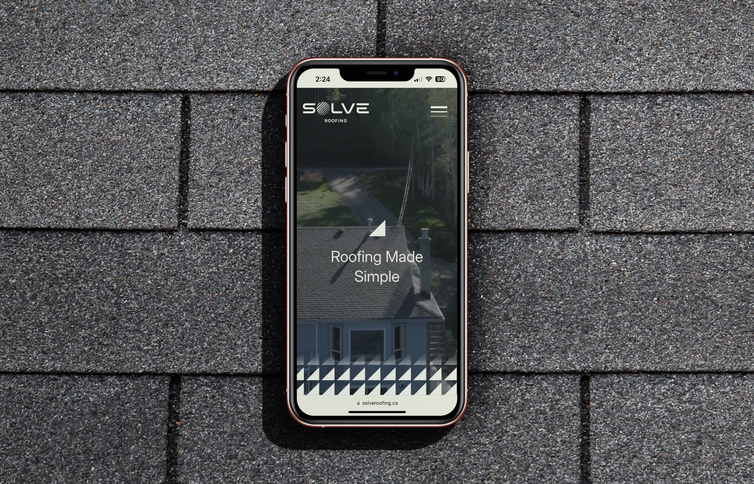 Mobile phone displaying the Solve Roofing website.
